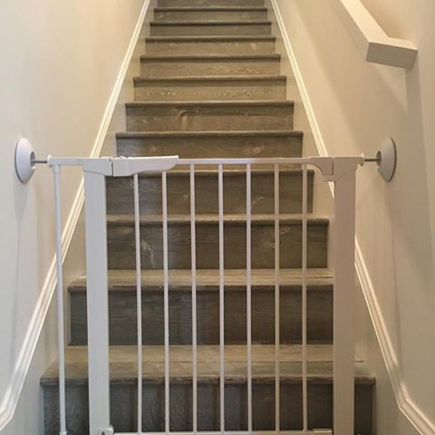 Bottom of stairs baby safety pressure gate installed by Baby Safe Homes San Diego